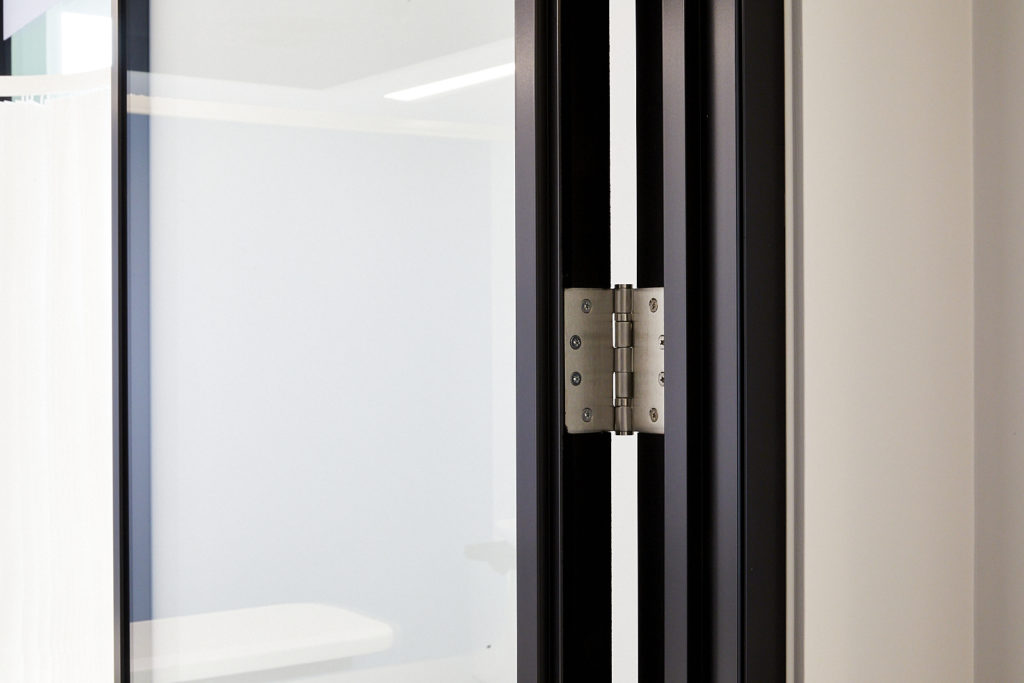 Hinge used to fix a glass office door within office partitioning