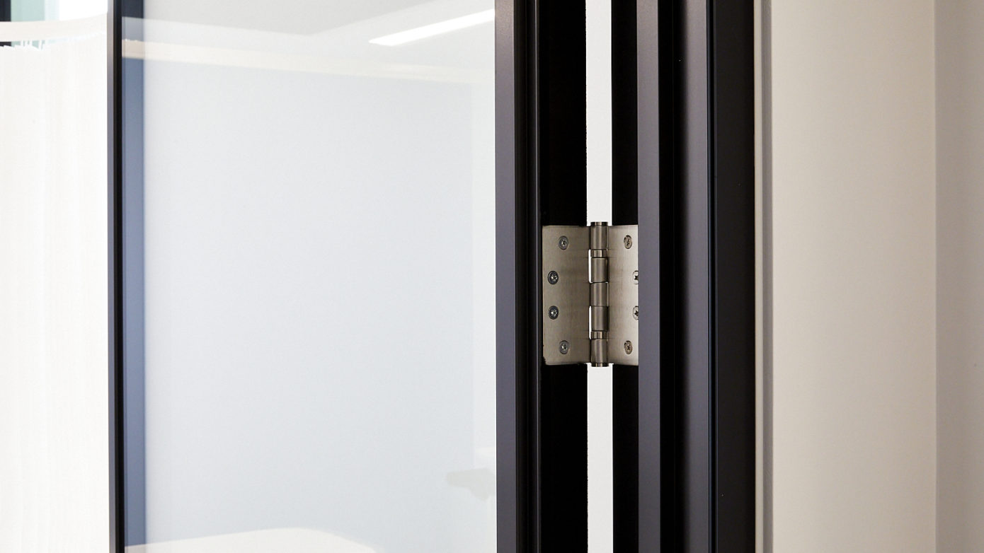 Hinge used to fix a glass office door within office partitioning